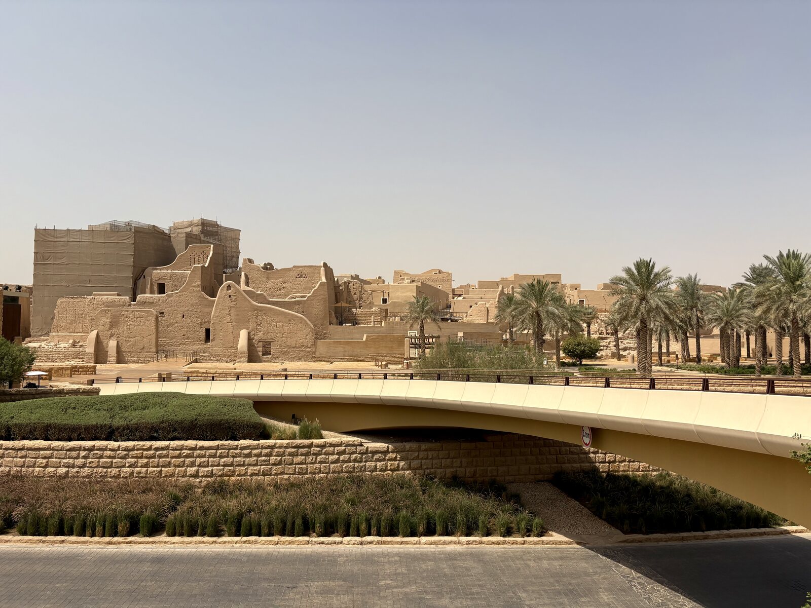 Mud-brick buildings and palm trees at At-Turaif in Diriyah